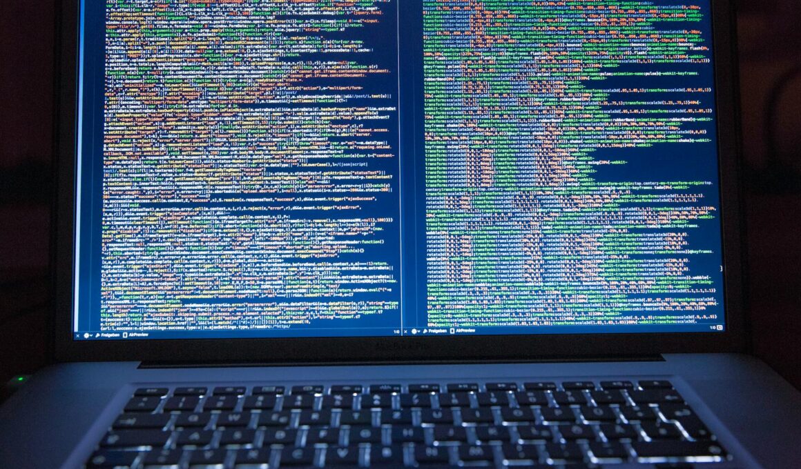 Laptop displaying source code with dual screens for software development.